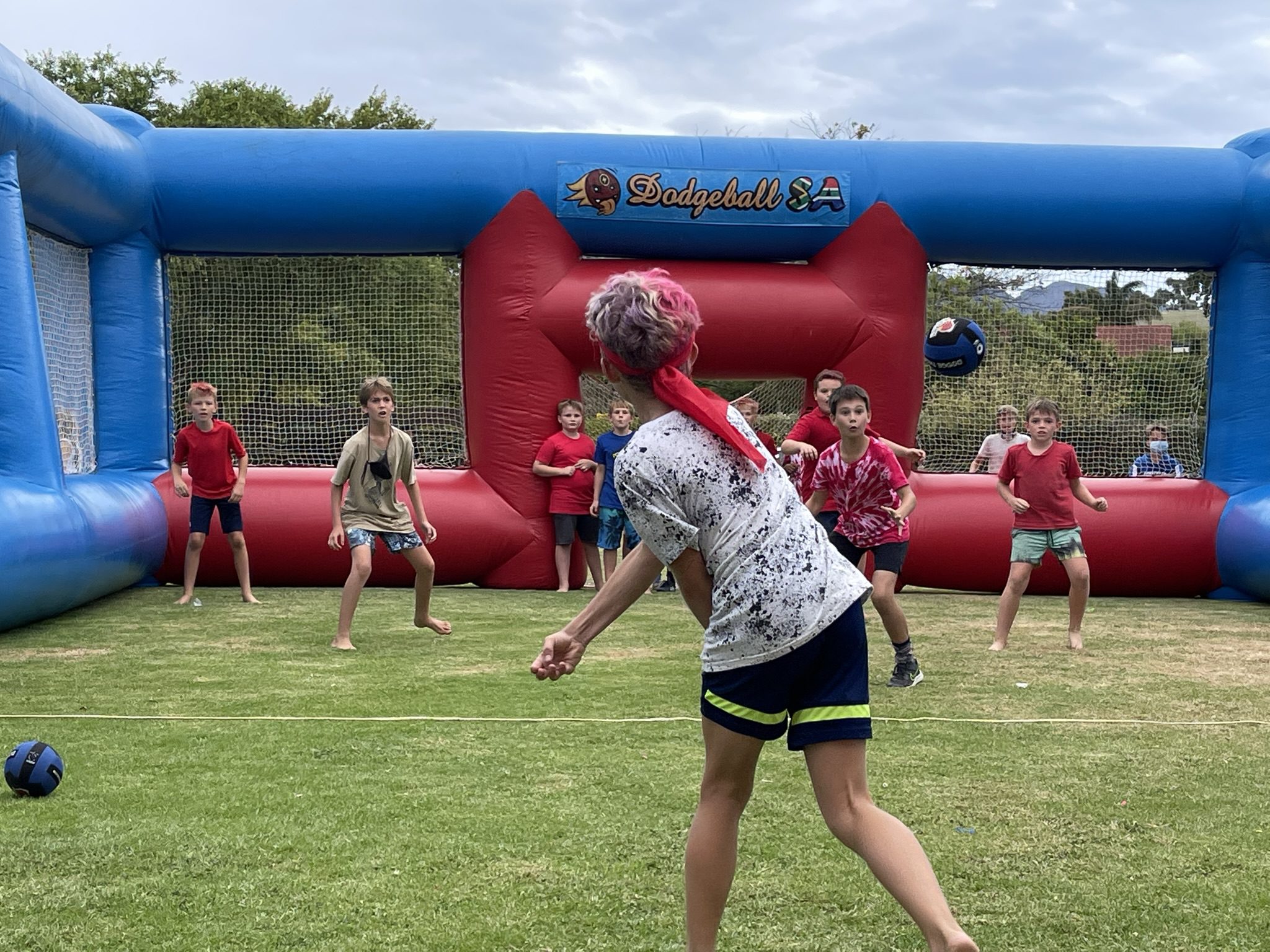 young boy dodgeball player throwing a dodgeball at the opposing team, at a dodgeball party hosted in in Cape Town.